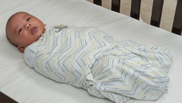 swaddle a baby in a blanket