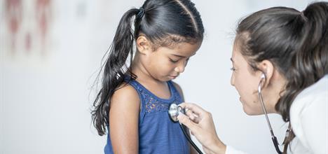 Young girl being examined by doctor.